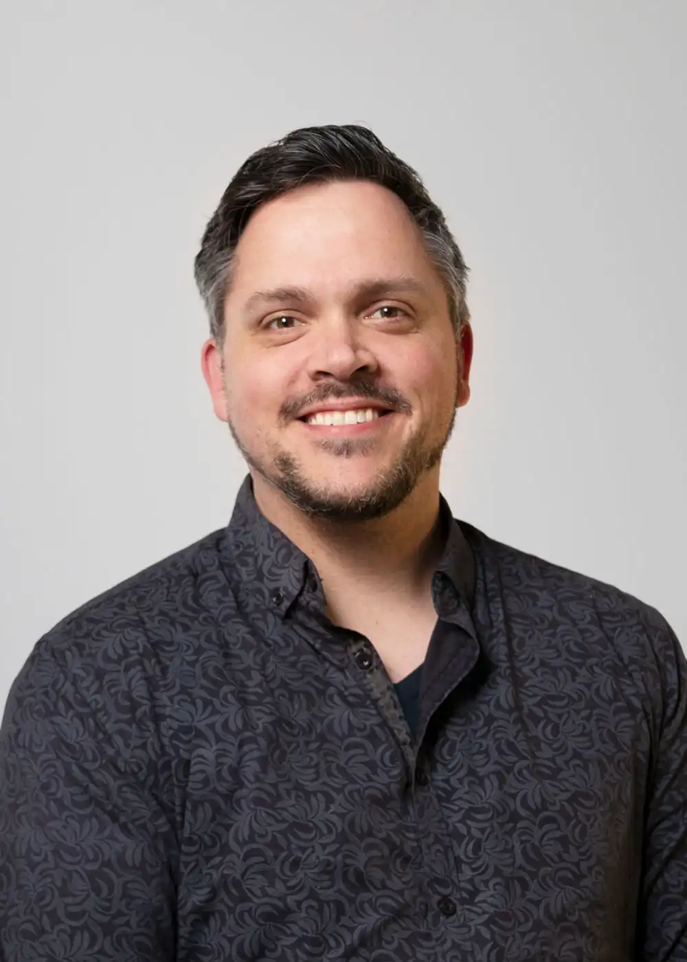 Portrait photograph of staff member Chris Mckenna